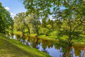 Fototapeta na wymiar Beautiful scenery in Brest Fortress in Belarus. Trees and Pond 