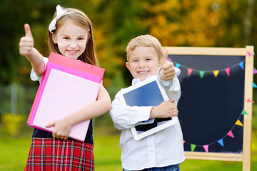 Two adorable schoolkids going back to school