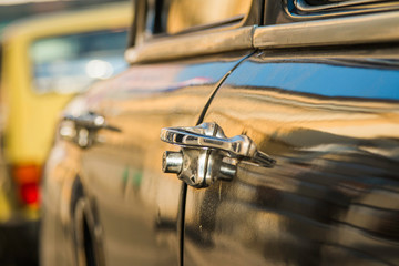 Old car parked on the street, door detail, selective focus 