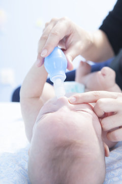 Mother Using Baby Nasal Aspirator