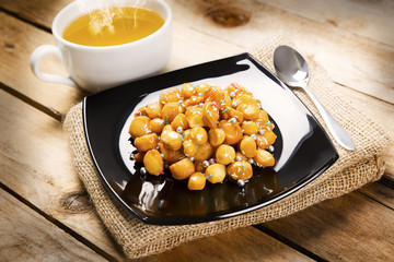 Struffoli with hot cup of chamomile