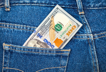 Banknote of one hundred american dollars in the back jeans pocke