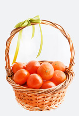 organic ripe mandarins in basket on white background