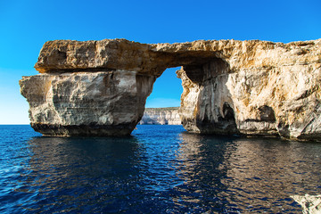 Azure Window, famous stone arch of Gozo island in the sun in summer, Malta.