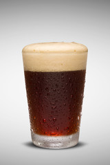 Glass of fresh beer with cap of foam isolated on white backgroun