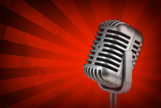 Retro microphone and vintage red background