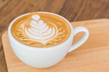 Close up cup of Coffee, latte on the wooden table