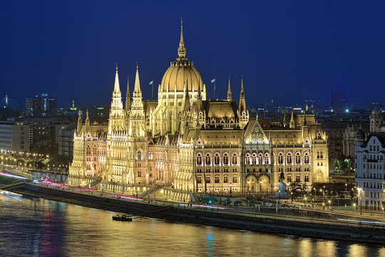 Eveninig view of the Hungarian Parliament Building in bright yellow illumination. View from Castle Hill in Budapest, Hungary.