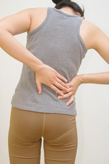 Attractive female person suffers from backache