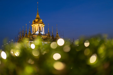 Obraz premium Loha Prasat Metal Palace in Wat ratchanadda with bokeh foreground, Bangkok, Thailand