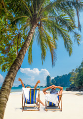 Couple on the beach at tropical resort Travel concept © Netfalls