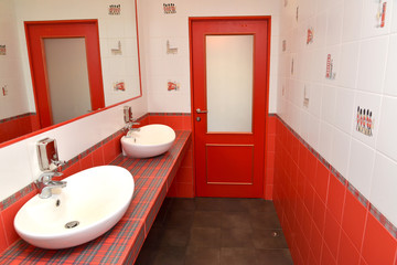 The washing room in a bathroom in red tones. Stylization under t