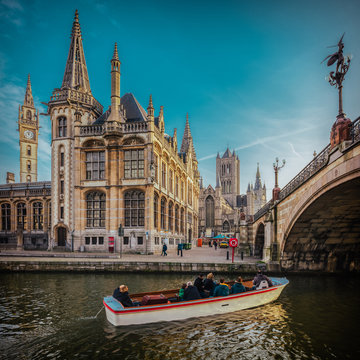 View over the Ghent, Belgium, as seen from the touristic boat, with a film warm colors emulation and high resolution, large panorama for huge prints