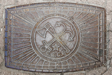 Old manhole cover on the street in Moscow. produced in the USSR