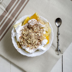 Bowl of healthy fresh fruit salad on wooden background.
