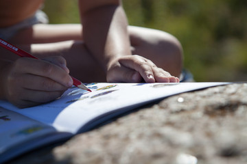 Boy's hand drawing a pencil