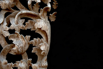 Thai wood carving of flowers on a black background