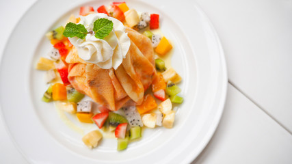 Fruit crape cake, Selective focus  at whip cream