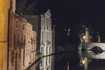 Buildings and Bridge over Canal at Night in Bruges