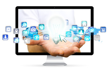 Businessman escaping from computer holding lightbulb and digital