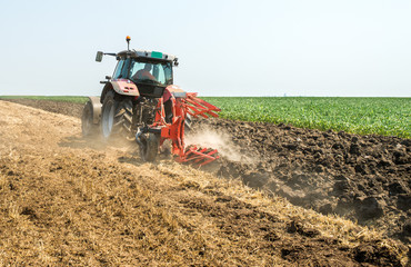 Tractor plowing field