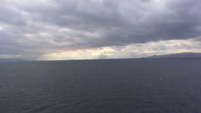 View of the dark sea against the cloudy sky.