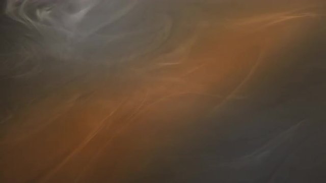 Orange beam shines through white fog as it drifts across the screen.  Recorded against black and intended for compositing with graphics or using a blending mode.  Looping clip.