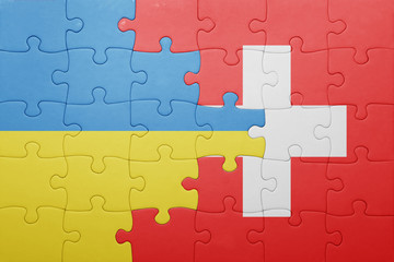 Fototapeta premium puzzle with the national flag of switzerland and ukraine