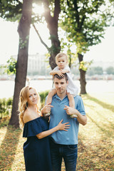 Fototapeta premium Family walking on a sunny day with a child