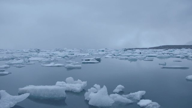 Blue icebergs floating on Jokunsarlon glacial lagoon