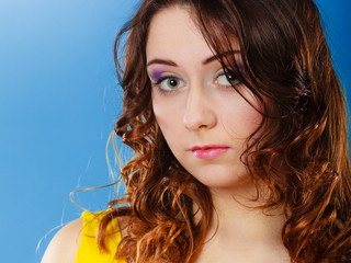 Closeup woman face long curly hair portrait