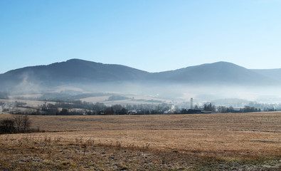 panorama of Beskydy mountains with mist in the valley