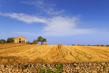 Papier Peint photo Été RURAL LANDSCAPE SUMMER.Harvested field with bales of hay.- (Apulia) ITALY-