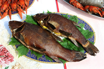 Freshly grilled tenches (Tinca tinca) on the plate in the open air restaurant