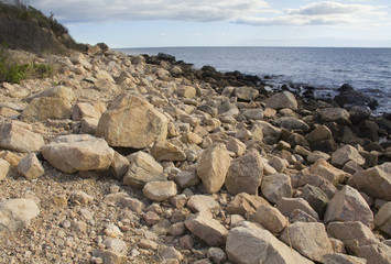Fototapeta na wymiar Boulders on the beach along southern coast of Connecticut on Long Island Sound.