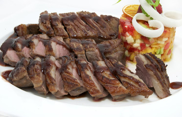 steak sauce and greens on a white background