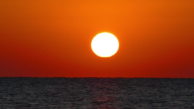 sea sunrise - shot with telephoto lens, 4k
