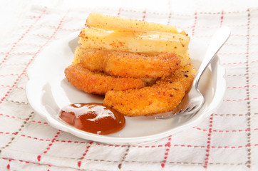 french fries with ketchup and breaded chicken nuggets
