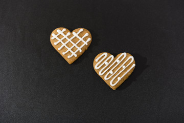 Two gingerbread hearts lying side by side