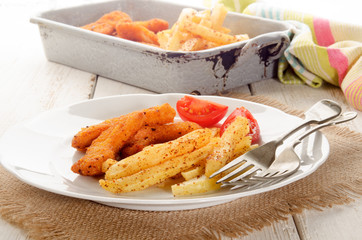 breaded chicken nuggets, french fries and tomato on a plate