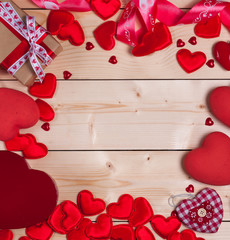 Valentine's day background with red hearts and gifts on wooden table.Place for your text.