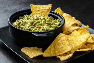Bowl of guacamole with corn chips