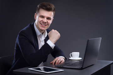Young Handsome Happy Director Sitting At The Table