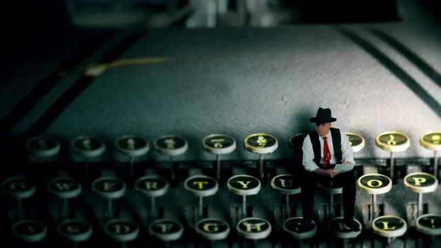 A tiny film noir style writer with pen and paper sitting on the keys of vintage 1940s typewriter writing a draft for his story.