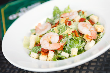 Caesar salad with shrimp and fresh vegetables. italian food.