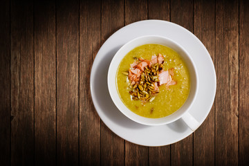 Portion of homemade pea soup with ham and sunflower seeds