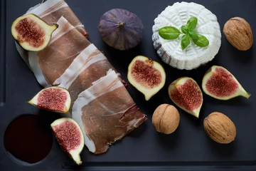 Fotobehang Assortiment Ricotta cheese with sliced ham, fresh fig fruits and walnuts  © Nickola_Che
