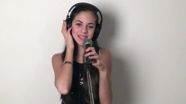 teen with headphones singing