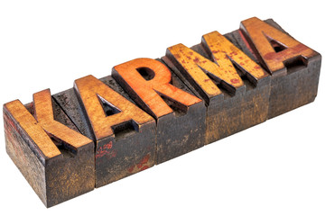 karma word abstract in wood type