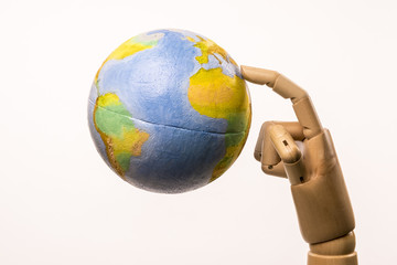 Hand points the index on the world globe. The world is crazy. Isolated on white background.